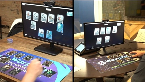 Promo image showing two different people playing a card game, with the cards on the playmats in front of them rendering on their laptop screens